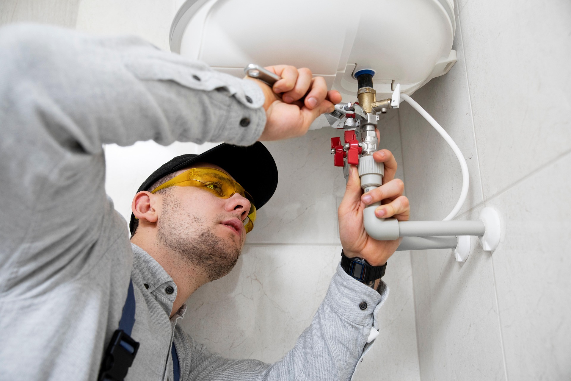 Plumber working on piping