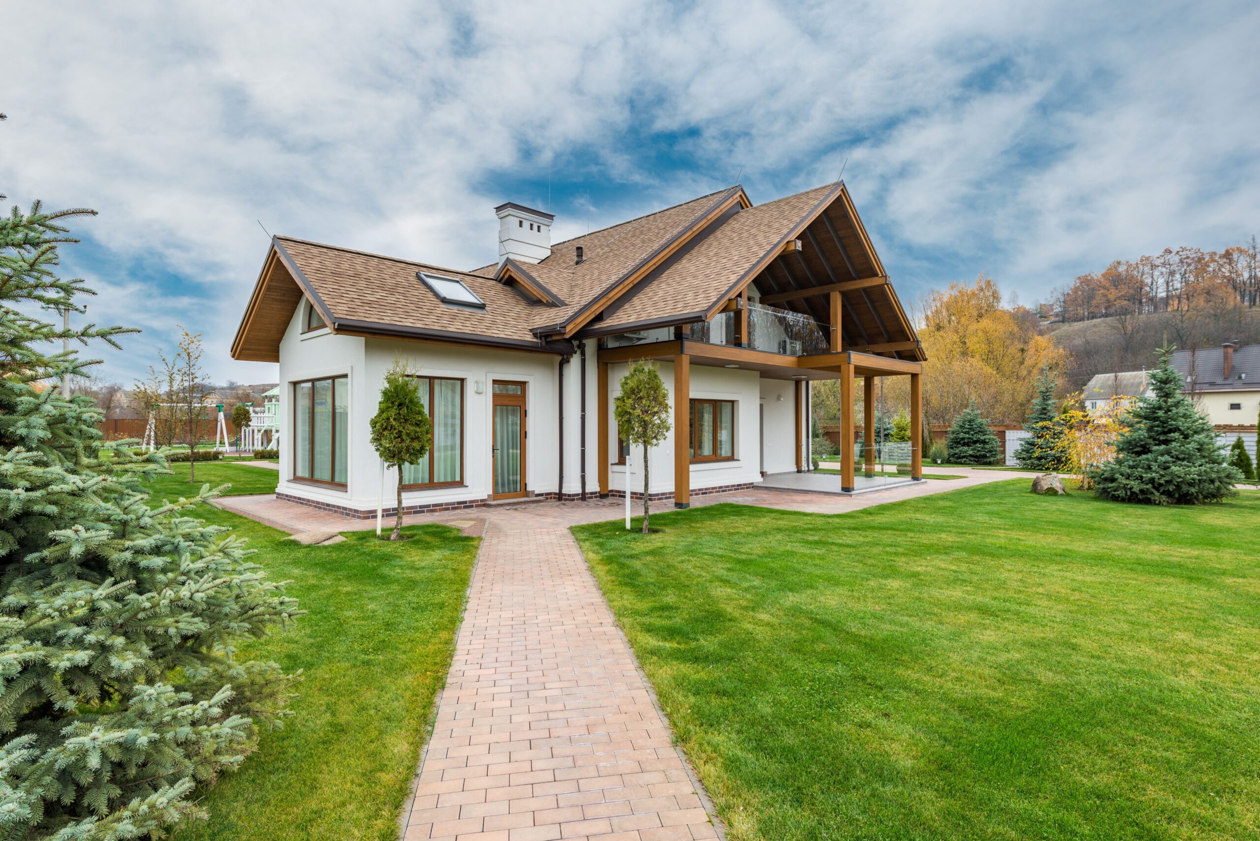 High-end detached American suburban home with attractive landscaping, exterior only